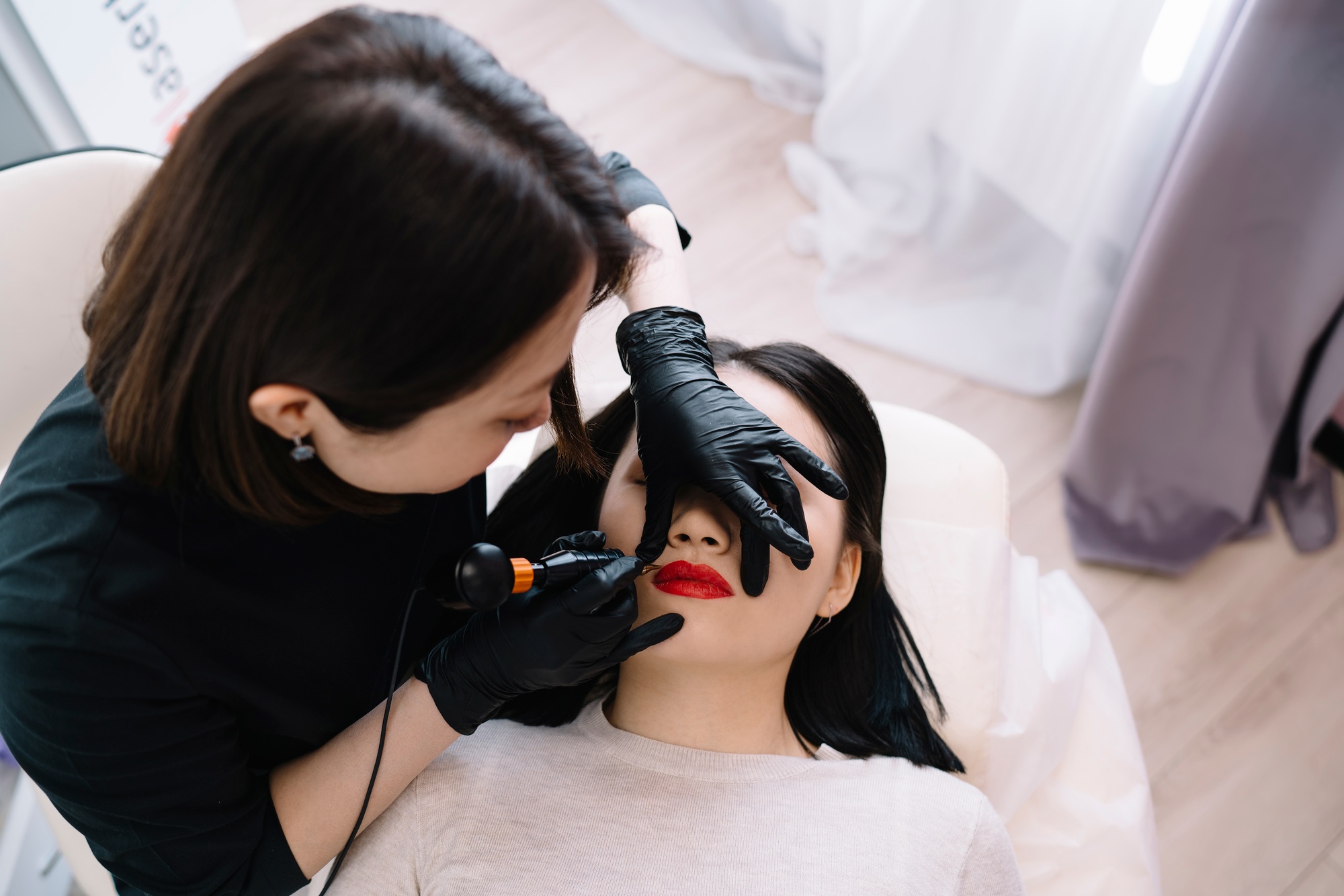Professional beauty specialist applying permanent makeup