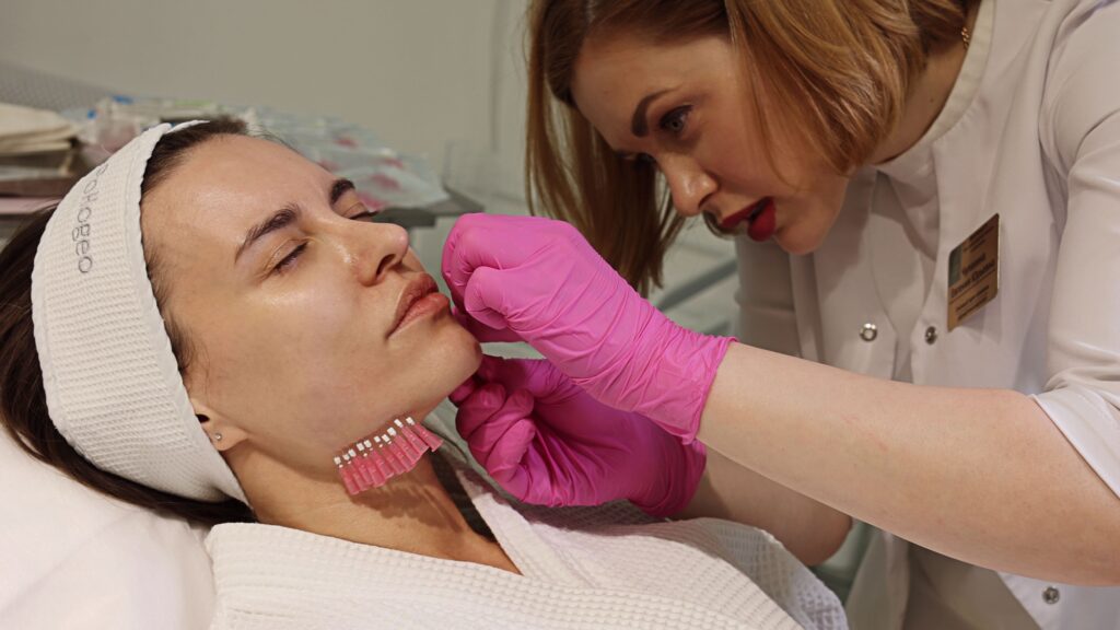 Woman doing cosmetology procedure, facial threads. Woman face lift